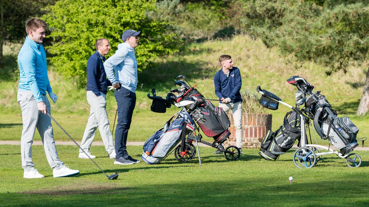 A golfer preparing to hit a drive