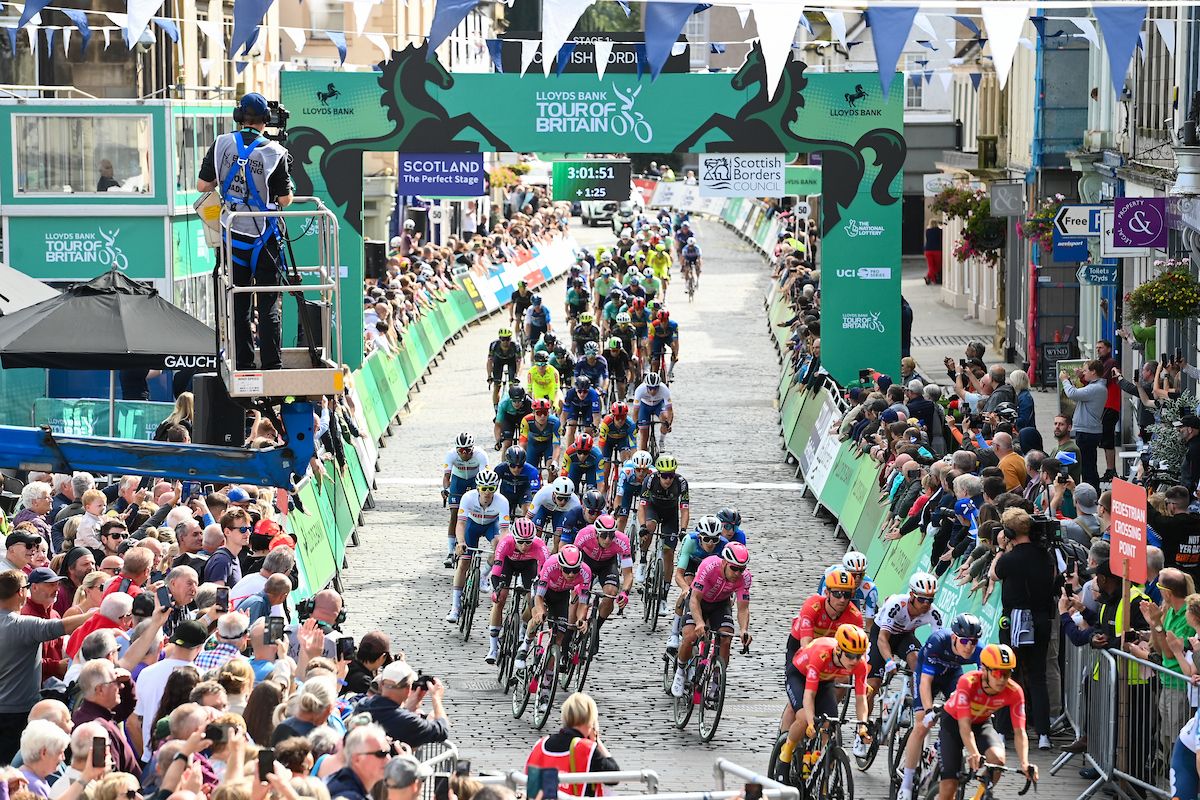 Picture by Simon Wilkinson/SWpix.com - 03/09/2024 - Lloyds Bank Tour of Britain 2024 - Stage 1: The Scottish Borders Stage, Kelso to Kelso, Scotland - The Peloton passes through the finish line for the first passage