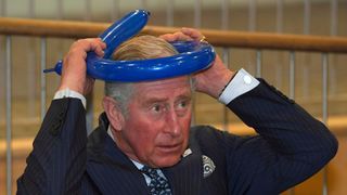 King Charles most memorable moments - 2017 school visit, Prince Charles learns how to make a balloon hat