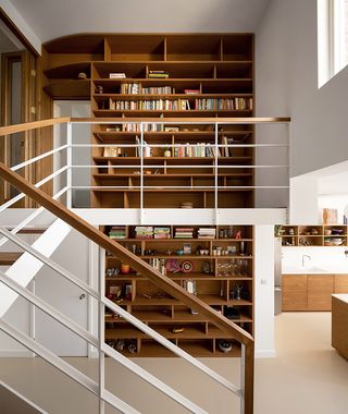 bespoke bookcase around staircase in modern london victorian house extension