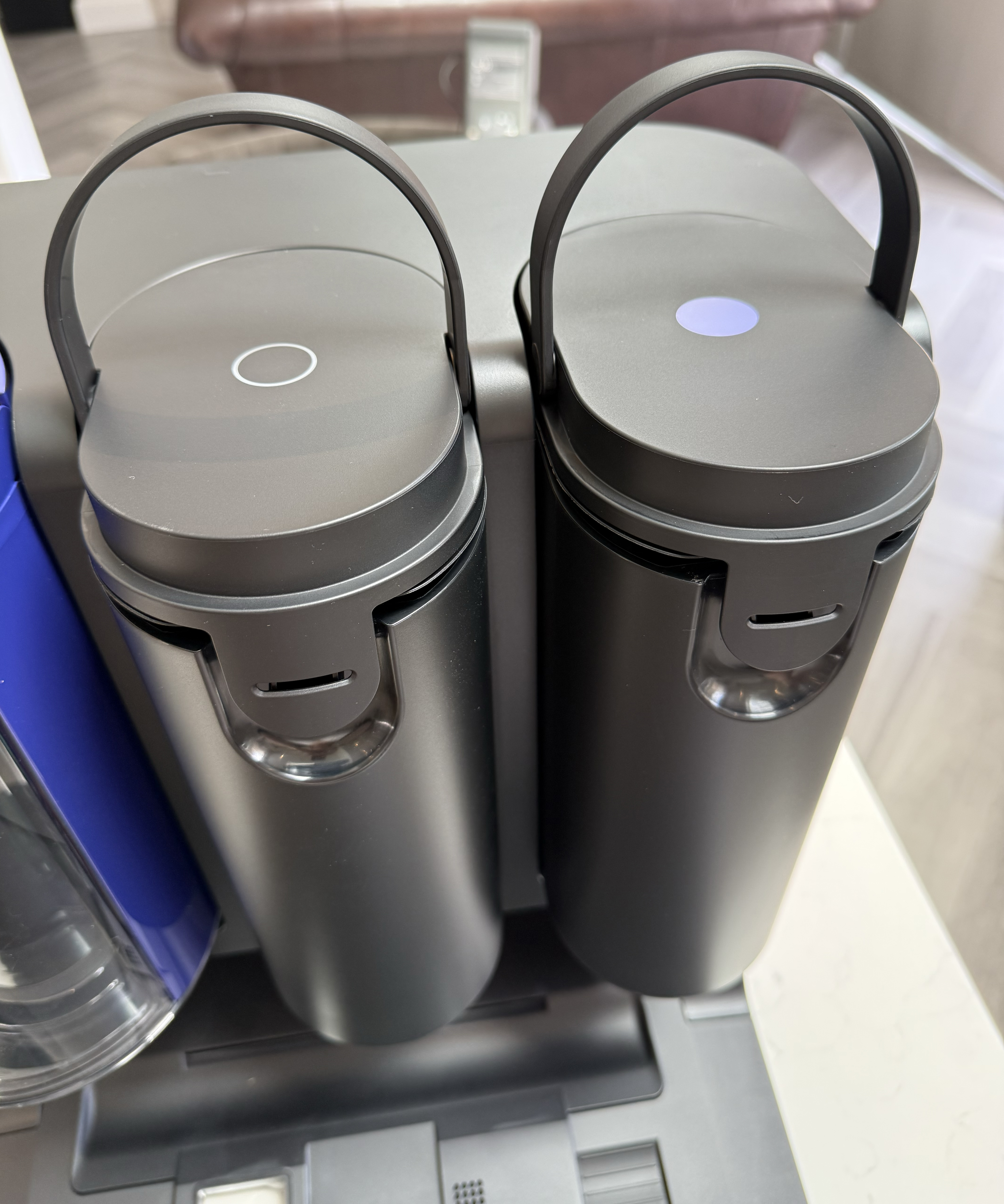 Close-up of the Dyson Spot+Scrub Ai clean and dirty water tanks with their lids open