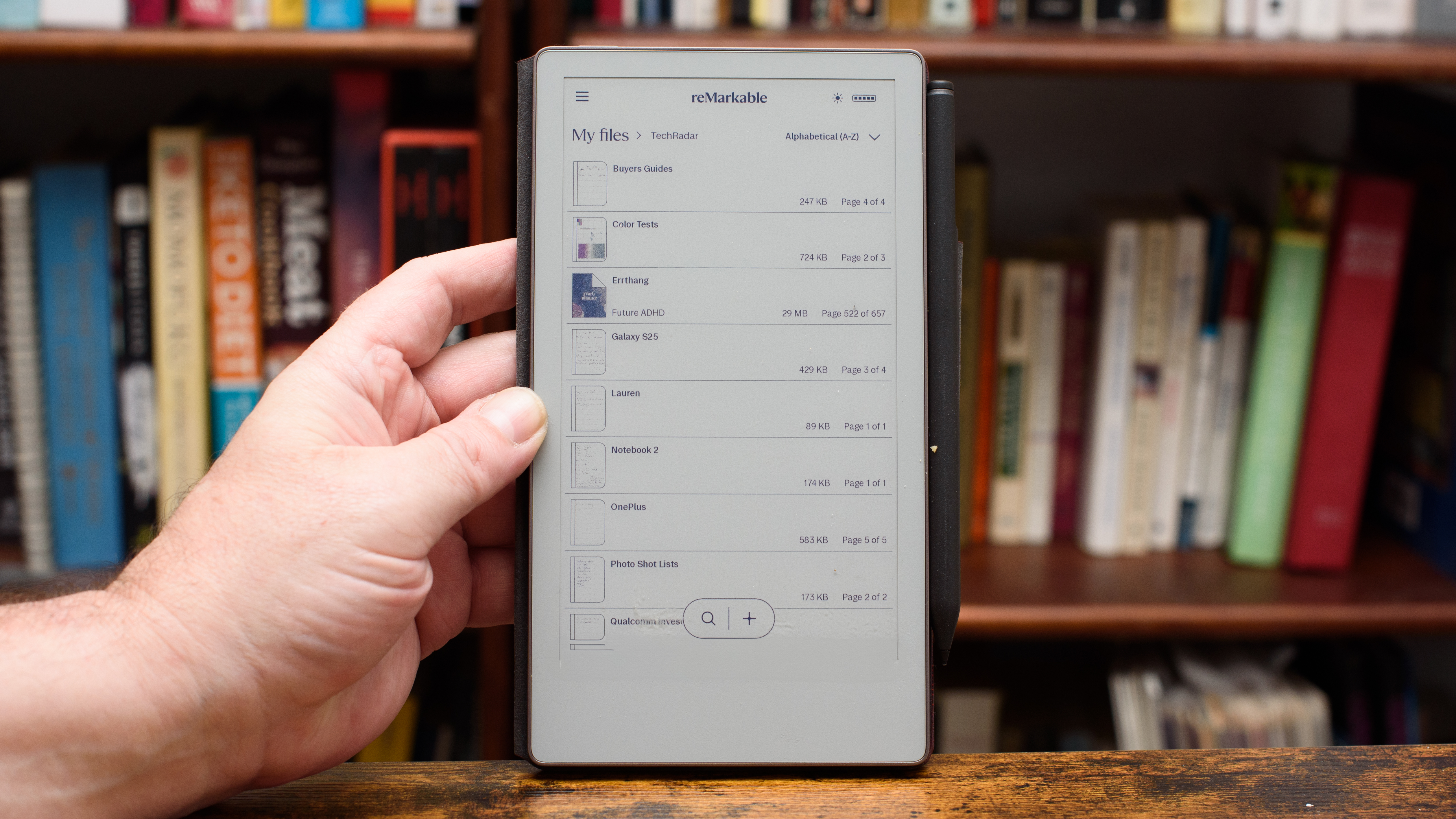 reMarkable Paper Pro Move tablet in front of a library of books, showing various writing screens and comparing the size to a Moleskine notebook