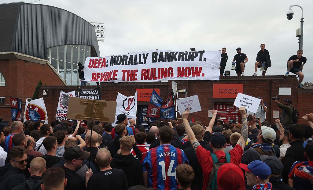 Crystal Palace fans protest their demotion from the Europa League to the Conference League