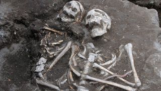 A grave with two skeletons together pinned down with an iron rod as they were believed to be vampires.