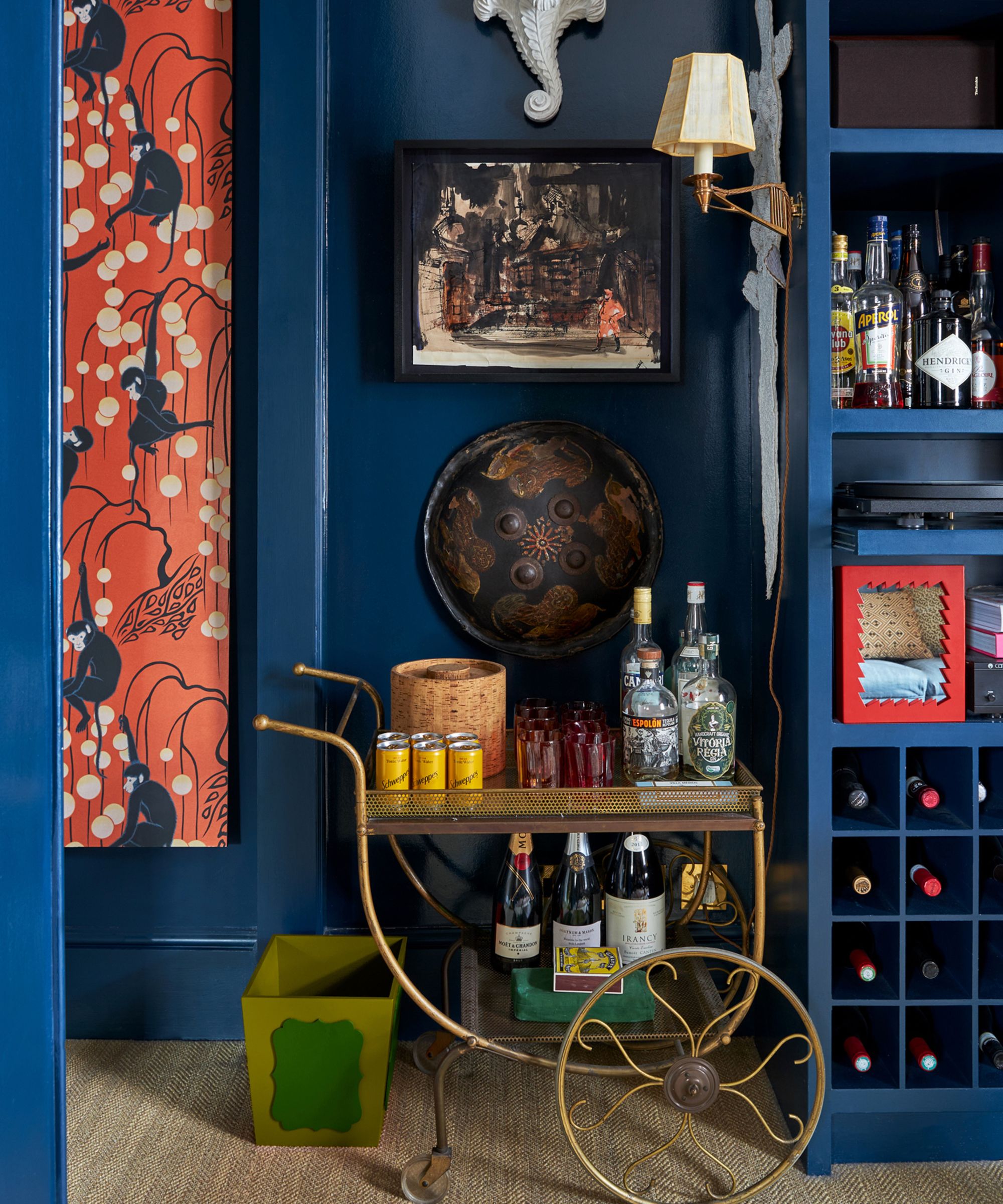 Brass bar cart in a blue room in Lucy Mayers home, Sibyl Colefax and John Fowler