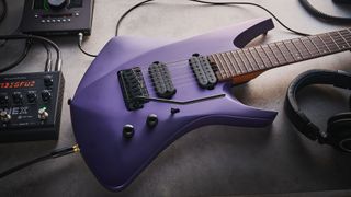 Sterling By Music Man Kaizen 7-string in Firemist Purple Satin, shot in close-up.