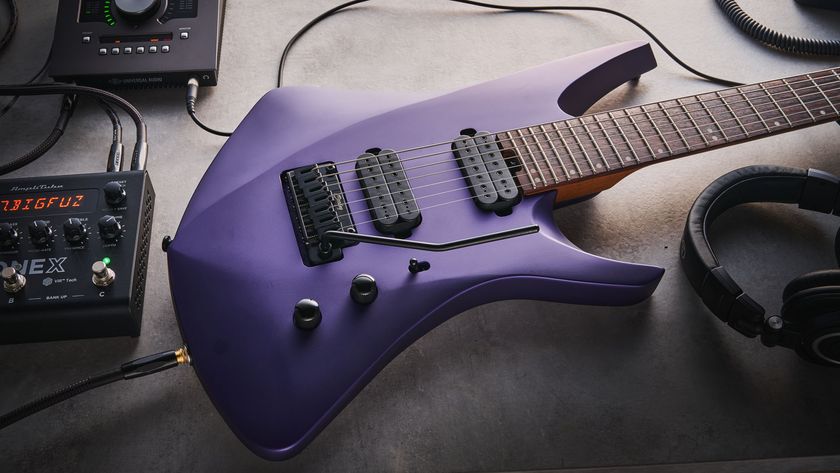 Sterling By Music Man Kaizen 7-string in Firemist Purple Satin, shot in close-up.
