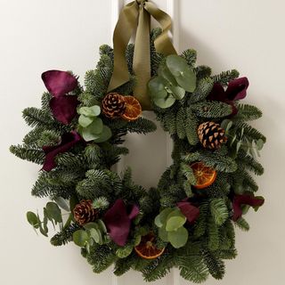 Festive wreath with green foliage and fruit