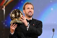 Harry Kane holding the 2026 Ballon d'Or