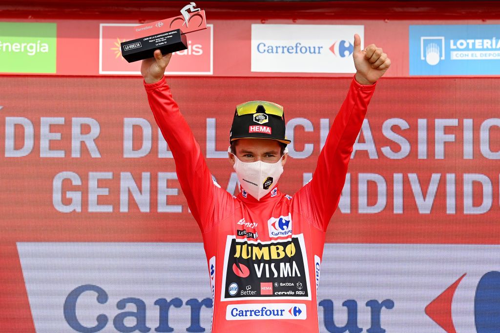 LA MANGA SPAIN AUGUST 21 Primoz Roglic of Slovenia and Team Jumbo Visma celebrates winning the red leader jersey on the podium ceremony after the 76th Tour of Spain 2021 Stage 8 a 1737 km stage from Santa Pola to La Manga del Mar Menor lavuelta LaVuelta21 on August 21 2021 in La Manga Spain Photo by Stuart FranklinGetty Images