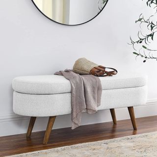 IAFIKE Oval Storage Bench in boucle fabric with handbag and clothes on top