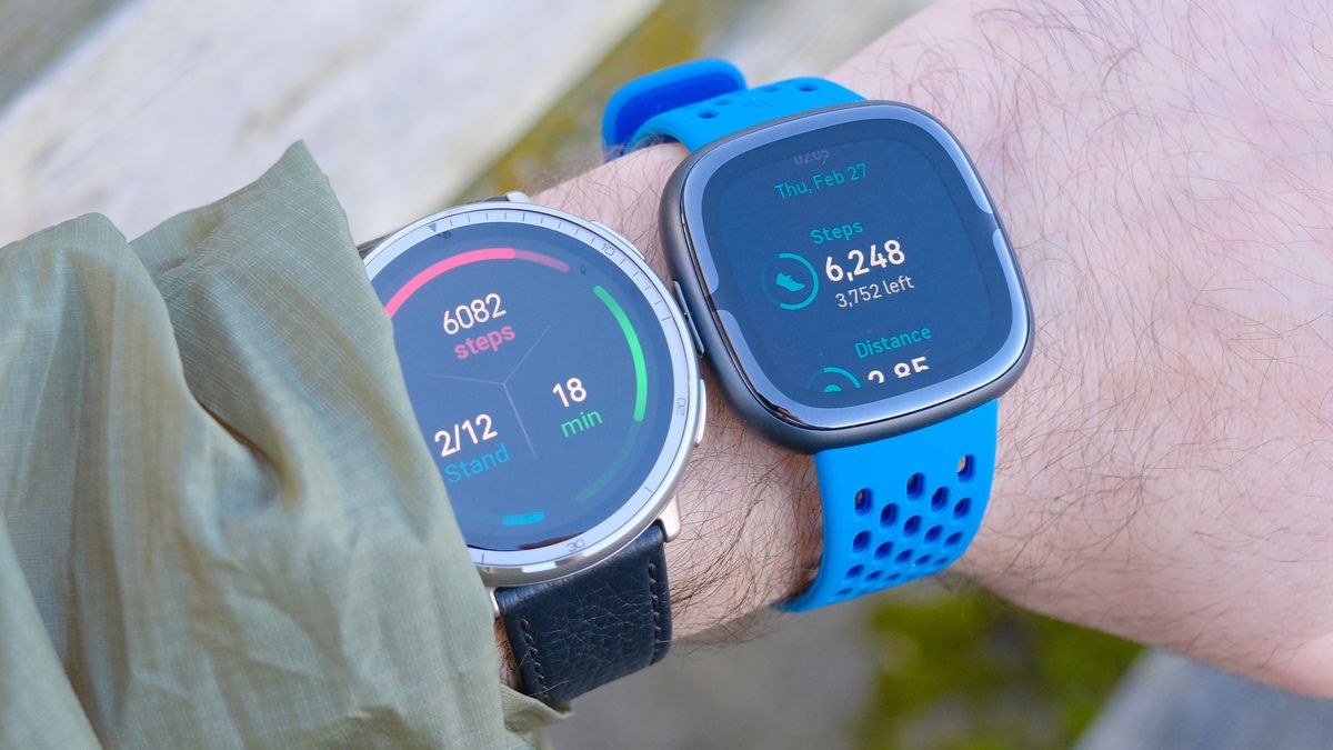 Close up of the Amazfit Active 2 smartwatch next to the Fitbit Sense 2 with each showing the total step count for the day