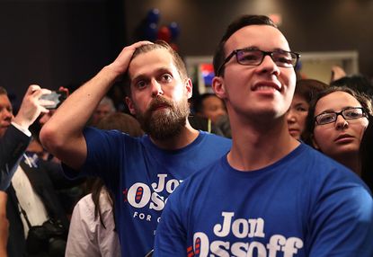 Jon Ossoff supporters react to the election results.