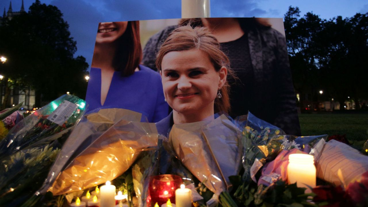 Floral tributes and candles are placed by a picture of Labour MP Jo Cox