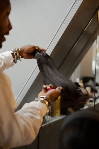 Hairstylist Issac Polen working on a clients hair during his Browns London residency