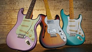 A selection of Made in China Fender Squier electric guitars, including (L-R) a Classic Vibe Stratocaster &rsquo;60s, Vintage Modified &rsquo;72 Telecaster Thinline and a Classic Vibe Stratocaster &rsquo;50s model, taken on November 13, 2014. 