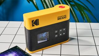 A black and yellow Kodak Mini Shot 3 Era 2-in-1 instant camera and printer