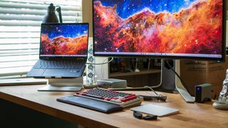 HP Elite Dragonfly Chromebook on a stand connected to an Ultrawide monitor