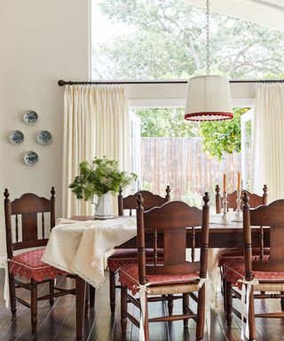 dining room with big picture window brown wood furniture