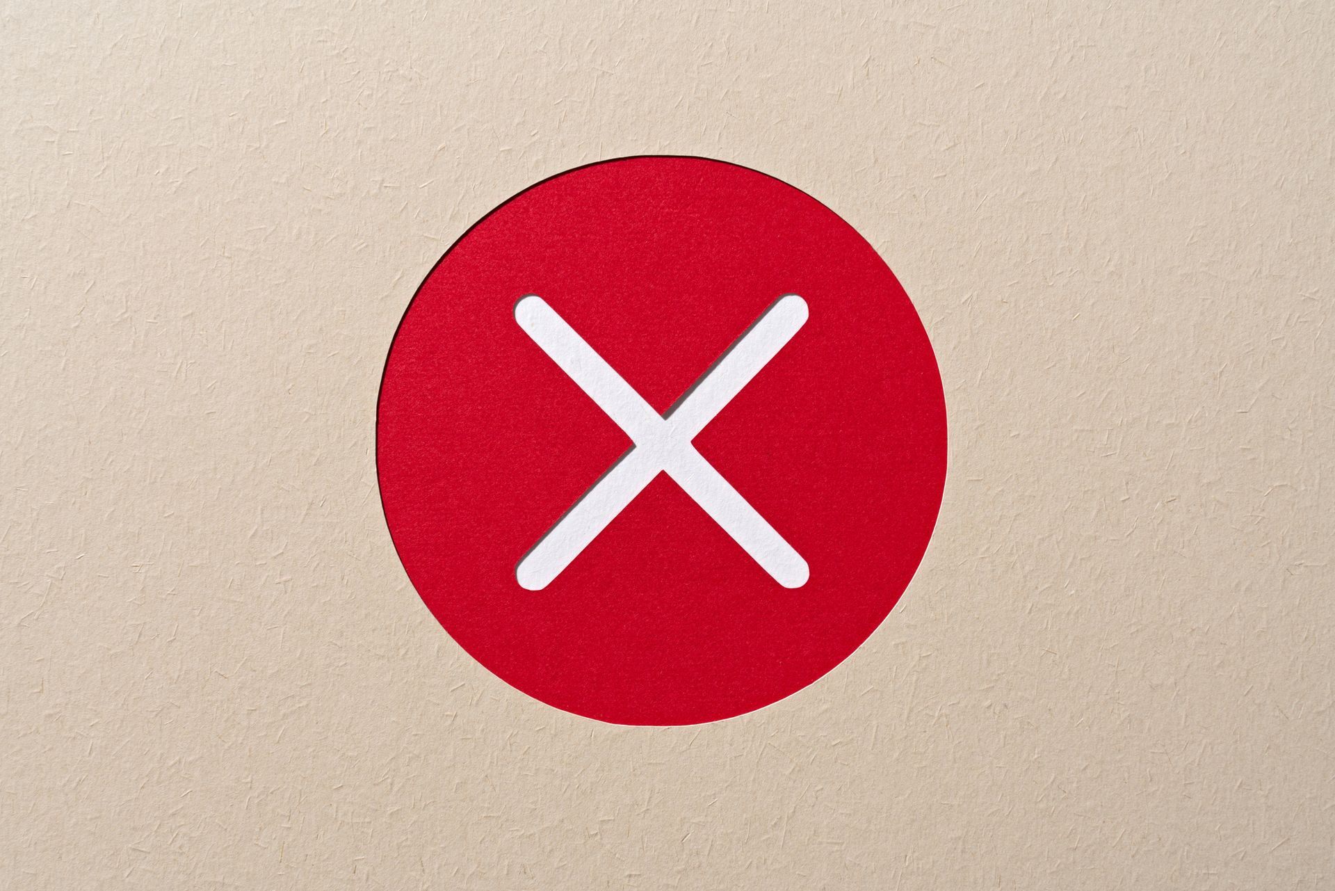 Paper Craft of Red Cross Mark in a Circle Frame on Beige Background.