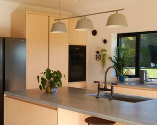 Warm neutrals contemporary kitchen scheme with island and sink, and minimal aesthetic