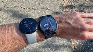 The Garmin Fenix 8 and Google Pixel Watch 3 worn on one wrist, each showing the 10-mile mark.