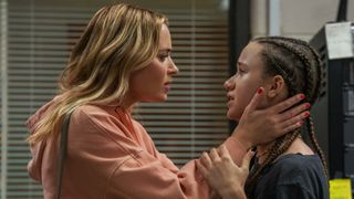 Emily Blunt and Chloe Coleman in an embrace in Pain Hustlers