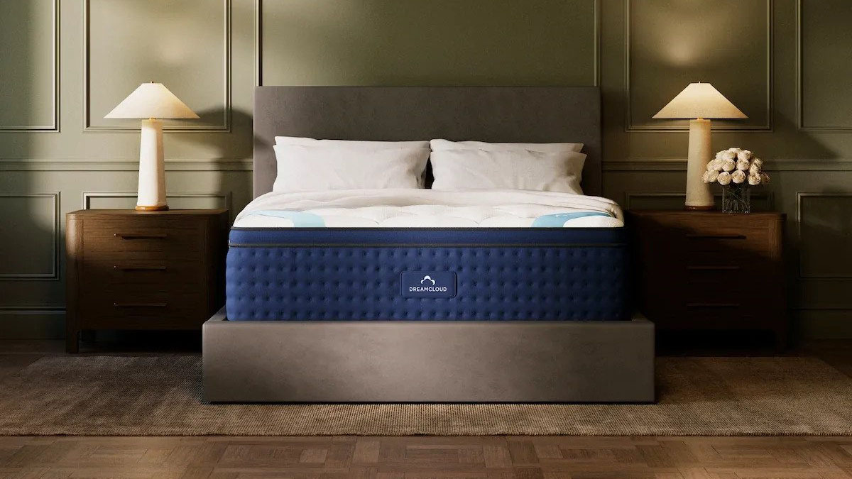 Image shows the DreamCloud Premier Hybrid mattress, the brand's best mattress for stomach sleepers, in a stylish, well-lit bedroom