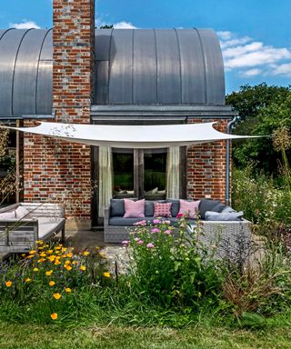 shade sail over seating on patio