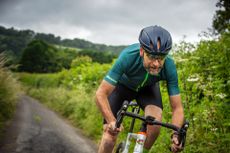 cyclist riding towards camera stress on shoulders