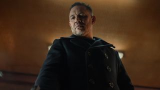 Tom Hardy looks down at the floor in MobLand