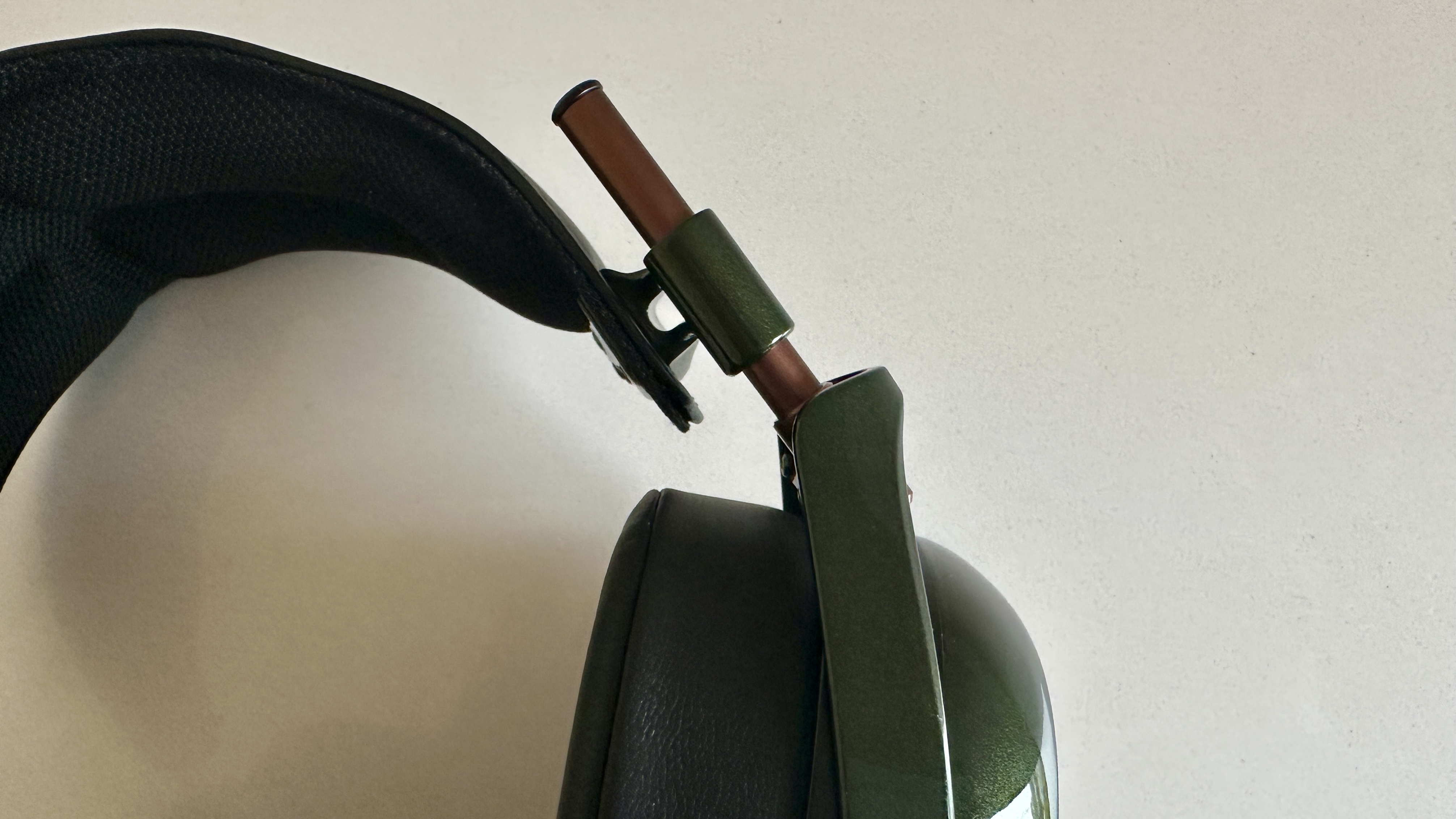 Meze Audio Strada headphones with wooden ear cups, in close-up and with their case and cables visible, on a white table