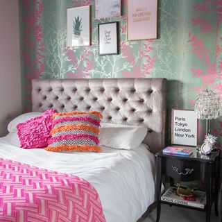 bedroom with grey headboard and textured wall