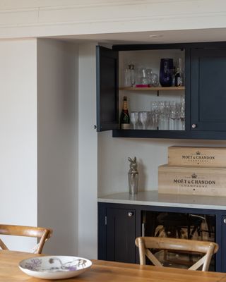 kitchen wall cupboard open with glassware inside