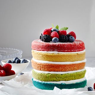 layered fruit cake and berries on top