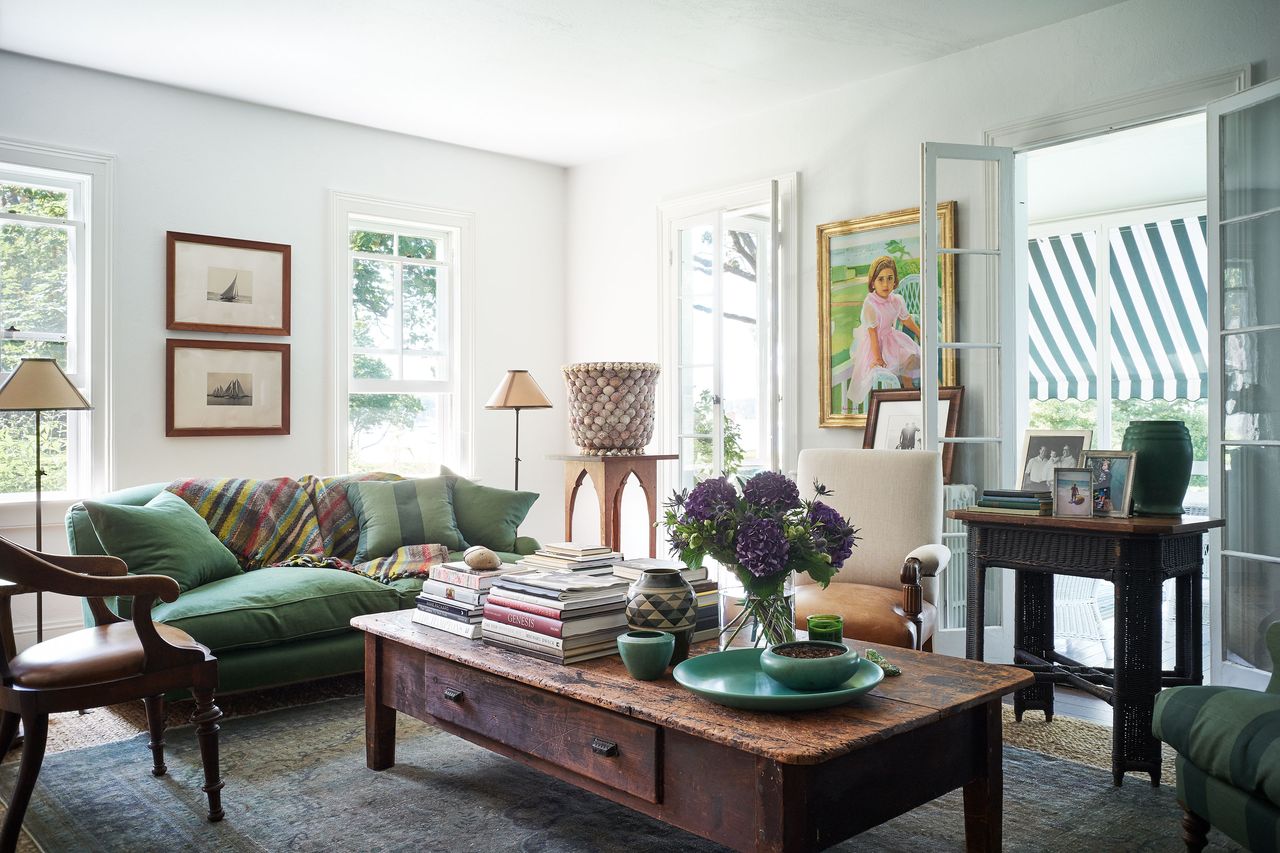 living room with white walls and green sofa low wooden coffee table 