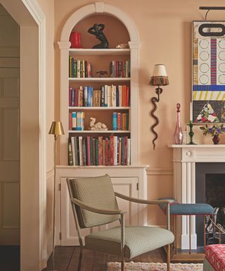 detail in living room with inbuilt arched top shelf and accent chair and pale pink walls