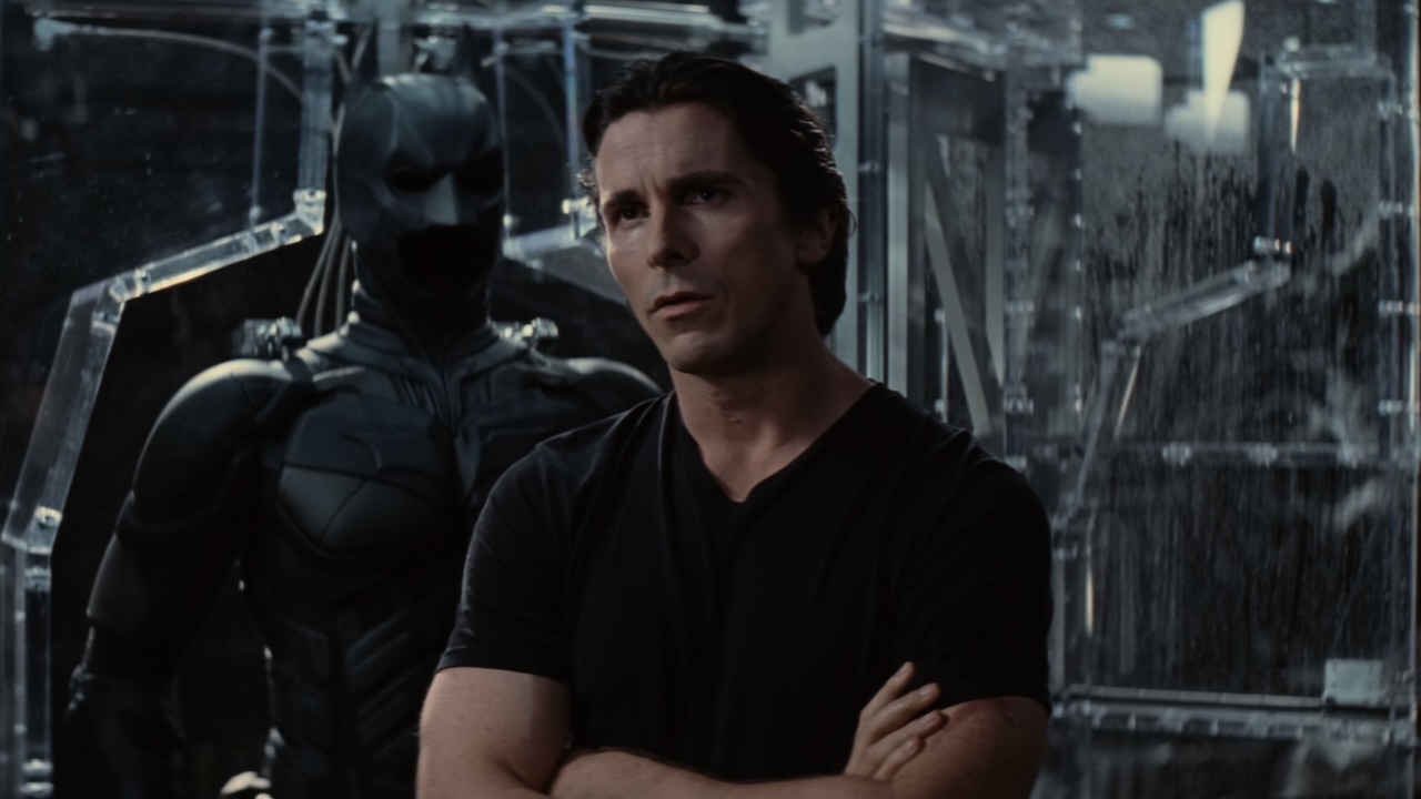 Christian Bale's Bruce Wayne standing near BatSuit in BatCave in The Dark Knight Rises