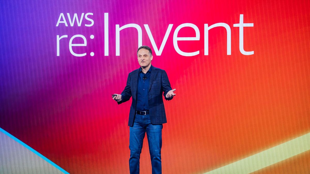 AWS CEO Adam Selipsky, standing on the keynote stage at AWS re:Invent in front of the words &amp;quot;AWS re:Invent&amp;quot; 