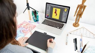 best Wacom tablet - Woman using Wacom tablet to draw on her laptop