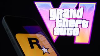 GTA VI logo from the trailer displayed on a laptop screen and Rockstar Games logo displayed on a phone screen