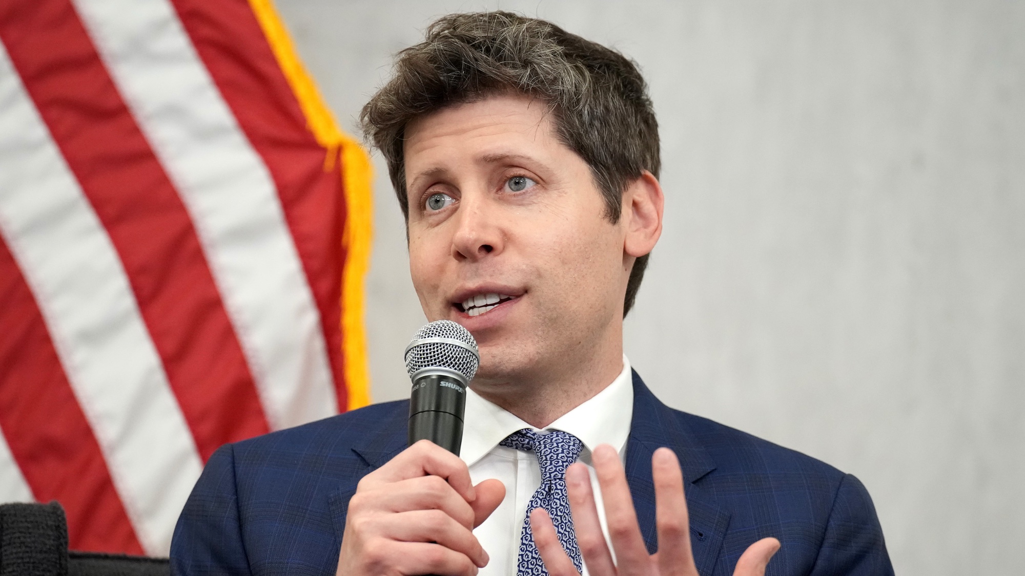 Sam Altman giving a speech at the Federal Reserve