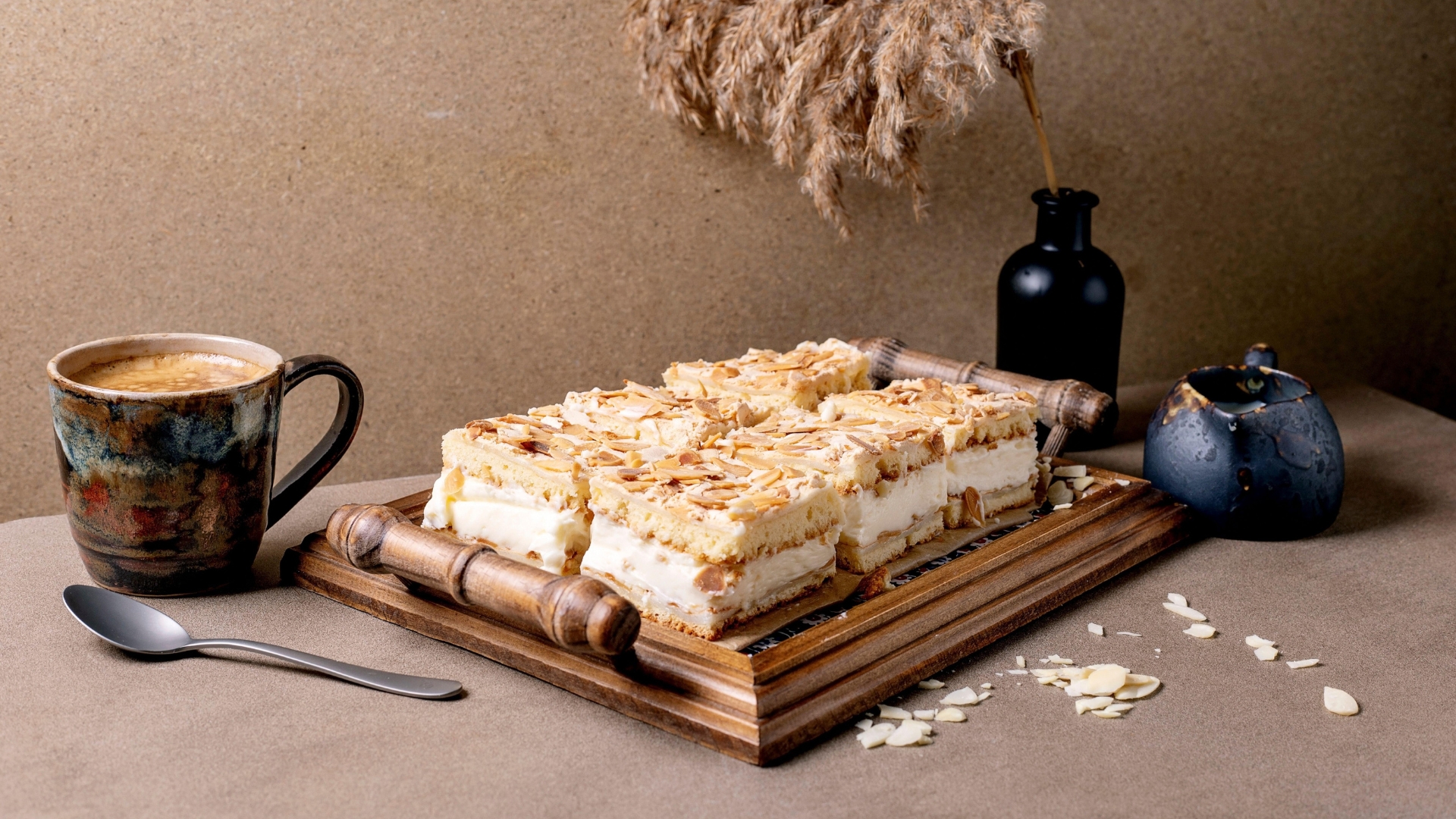 Norway's Kvæfjordkake on a wooden tray next to a cup of tea