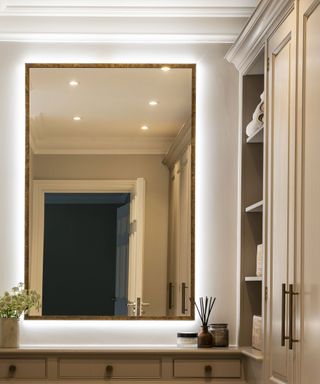 Bedroom dressing area with large mirror and shelves