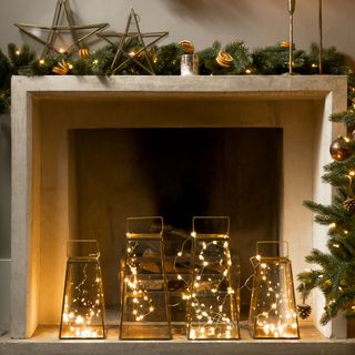 Modern mantelpiece decorated with fairy lights for Christmas
