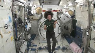 Irish astronaut Cady Coleman displays a flute and a pennywhistle on loan from the Irish band The Chieftains while flying in the Japanese Kibo lab on the International Space Station on St. Patrick's Day, March 17, 2011.