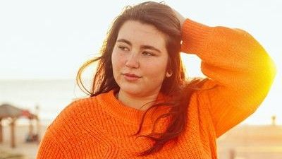 Woman in Orange Jumper