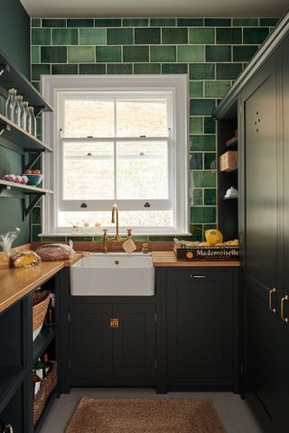 narrow utility room ideas with bright green tiles and butler sink