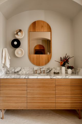 A white bathroom with wooden accents