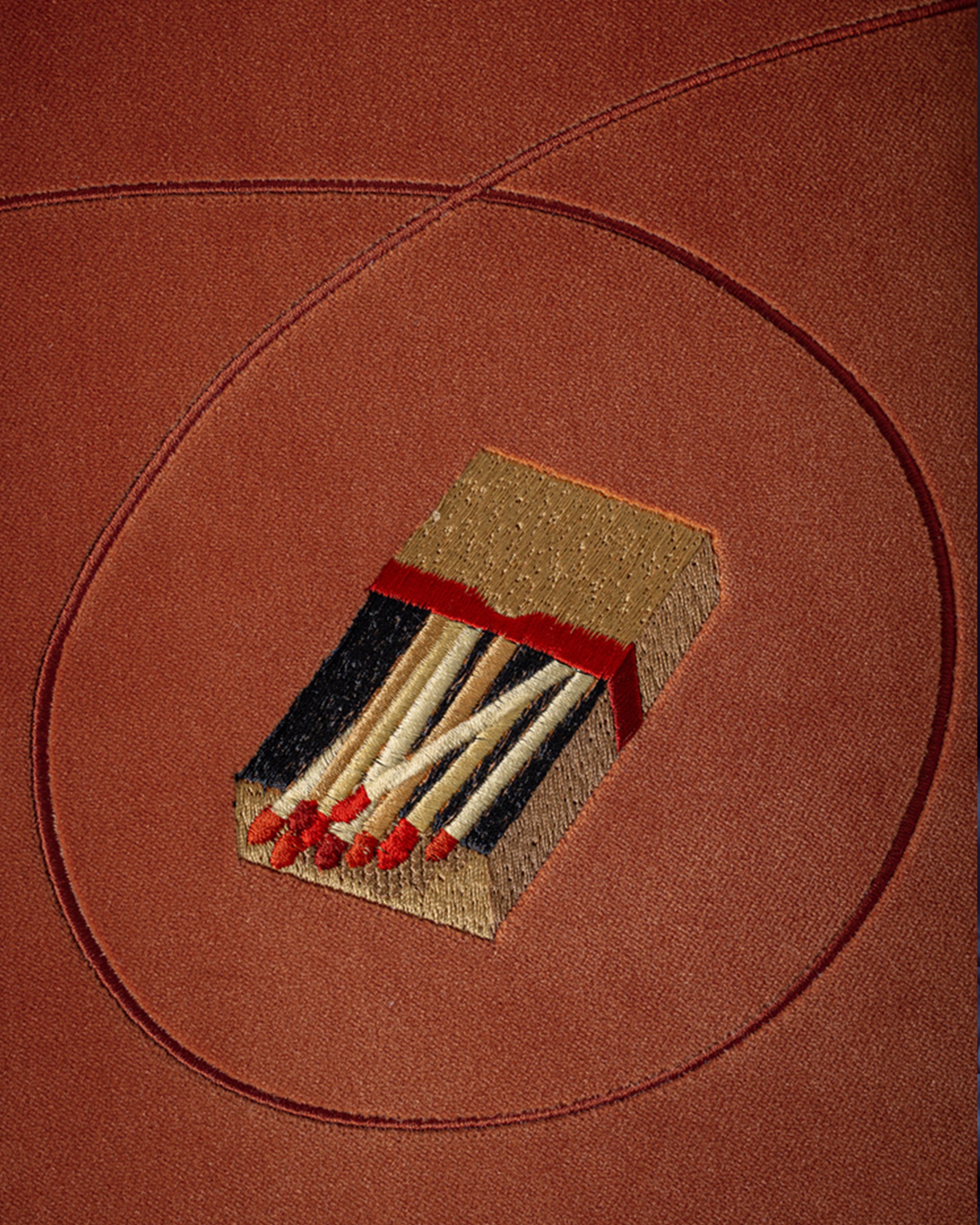 embroidered motifs on a velvet footstool